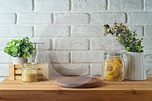 Empty wooden log on kitchen table over white brick wall background. Kitchen mock up for design and product display