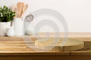 Empty wooden log on rustic table over kitchen shelf background.  Interior mock up for design and product display