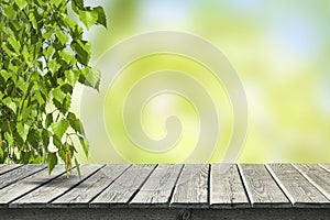 Empty wooden old table top for product display on blurred garden and summer season background