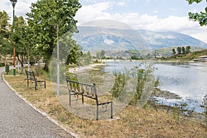 Empty wooden park bench overlooking Viroi lake