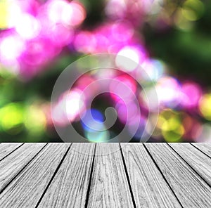 Empty Wooden Perspective Platform with Sparkling Abstract Rainbow Blur Bokeh used as Template to Mock up for Display Product