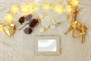 Empty wooden photo frame over cozy and warm fur carpet. For photography montage. Top view.