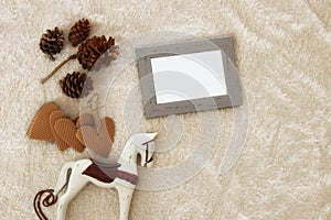 Empty wooden photo frame over cozy and warm fur carpet. For photography montage. Top view.