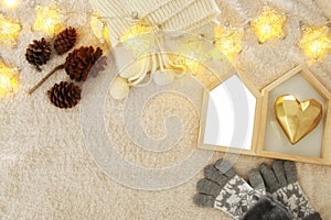 Empty wooden photo frame over cozy and warm fur carpet. For photography montage. Top view.