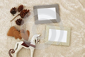 Empty wooden photo frames over cozy and warm fur carpet. For photography montage. Top view.