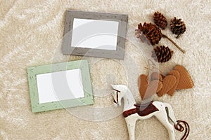 Empty wooden photo frames over cozy and warm fur carpet. For photography montage. Top view.