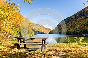 Empty Wooden Picnic Table near the Shore of a Mountain Lake