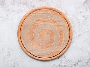 Empty wooden pizza platter set up on white concrete. Pizza board on white concrete background flat lay and copy space