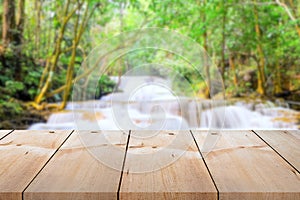 Empty wooden plank long table top on vintage style on blurred waterfall background