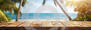 Empty wooden planks table against a blurred background with a sea coast with palm trees during the day, banner