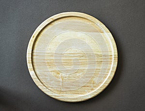 Empty wooden plate on brown background