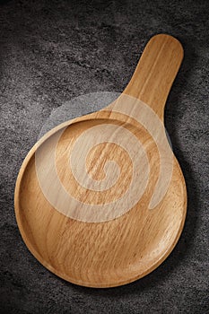 Empty wooden plate  on dark background