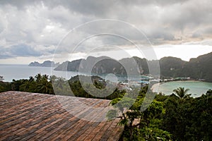 Empty wooden platform with Phi Phi island views and cloudy sky
