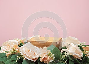 Empty wooden podium beige rose bouquet flowers decoration on pink background with space.beauty cosmetic and romantic valentines or