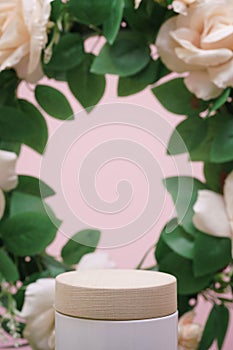 Empty wooden podium beige rose bouquet flowers decoration on pink background with space.beauty cosmetic and romantic valentines or