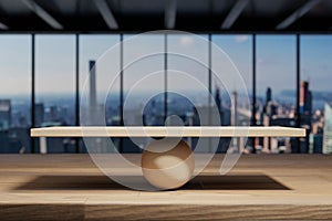Empty wooden scale with sphere on desk in modern office, skyline view, 3D Illustration