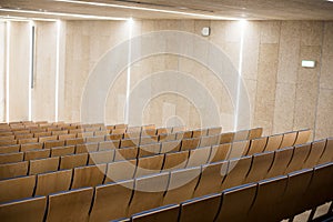 Empty wooden seats in a conference room