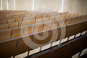 Empty wooden seats in a conference room