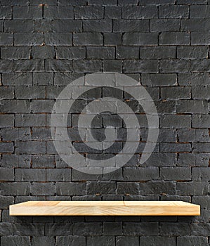 Empty Wooden shelf at black brick wall,Template mock up for display of product,business presentation