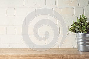 Empty wooden shelf with plant over brick wall interior. Kitchen mock up for design