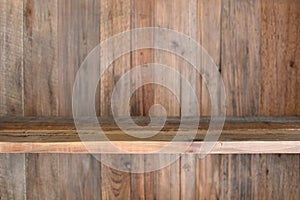 Empty wooden shelf on a wooden wall background texture. Copy space
