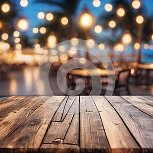 Empty wooden table and abstract blurred background of cafe with bokeh light. Wooden table with blur beach cafes background and bok