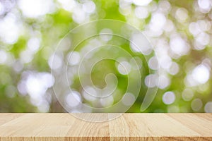 Empty wooden table with abstract bokeh light background for montage of product