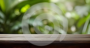 Empty wooden table against a blurry tropics background. Advertising background