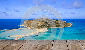 Empty wooden table with amazing view over Balos Lagoon and Gramvousa island on Crete, Greece