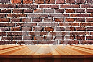 Empty wooden table andold brick wall