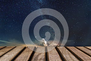 Empty wooden table andsky in the night background