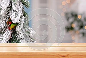 Empty wooden table on the background of a Christmas branch christmas tree,bumps and christmas porch. Merry Christmas and Happy New