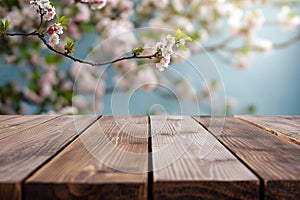Empty wooden table with blooming spring garden background. Display with spring nature, cherry branches. Free space for product