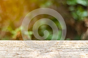 Empty wooden table on blur abstract green in the morning background. For montage product display.