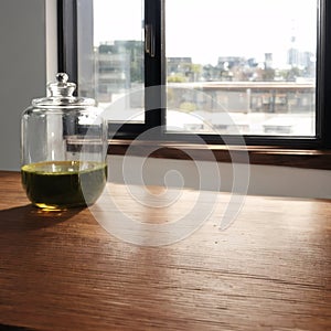The empty wooden table and blur glass wall background window room interior decor...