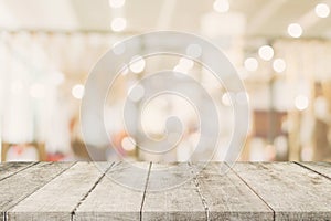 Empty wooden table with blurred abstract people on cafe on restaurant background.