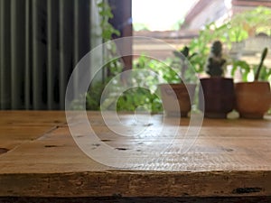Empty wooden table with blurred cafe background.