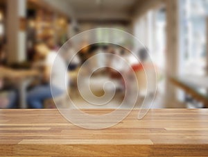 Empty wooden table and blurred cafe background