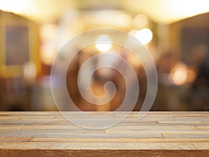 Empty wooden table and blurred cafe background