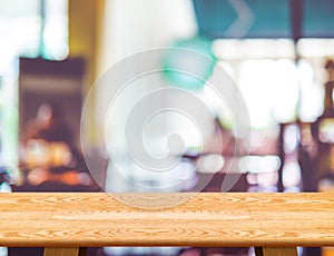 Empty wooden table and blurred cafe bokeh light background. Mock