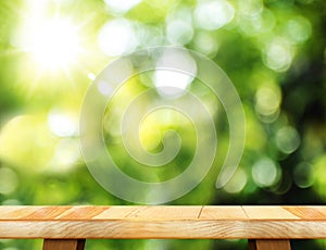 Empty wooden table and blurred garden bokeh light background. Mo