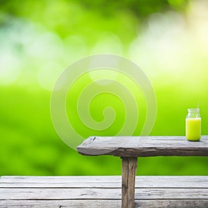 Empty wooden table with blurred green garden background. For product display