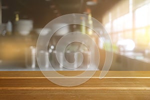 Empty wooden table and blurred kitchen interior background
