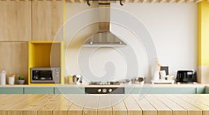 Empty wooden table and blurred kitchen yellow wall background/Wood table top on blur kitchen counter