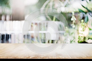 Empty wooden table with blurred outdoor garden background