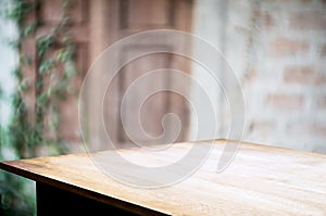 Empty wooden table with blurred outdoor garden background