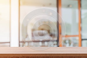 Empty wooden table and blurred people in coffee shop background, product display montage.