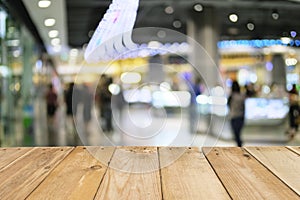 Empty wooden table of brown blurred shopping mall background,