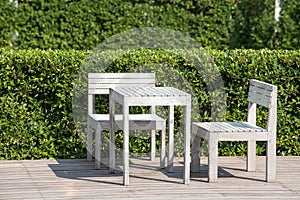 Empty wooden table and chairs of a tropical garden
