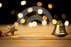 Empty wooden table with christmas lights and decoration, golden sparkles and bokeh. Holiday and new year background